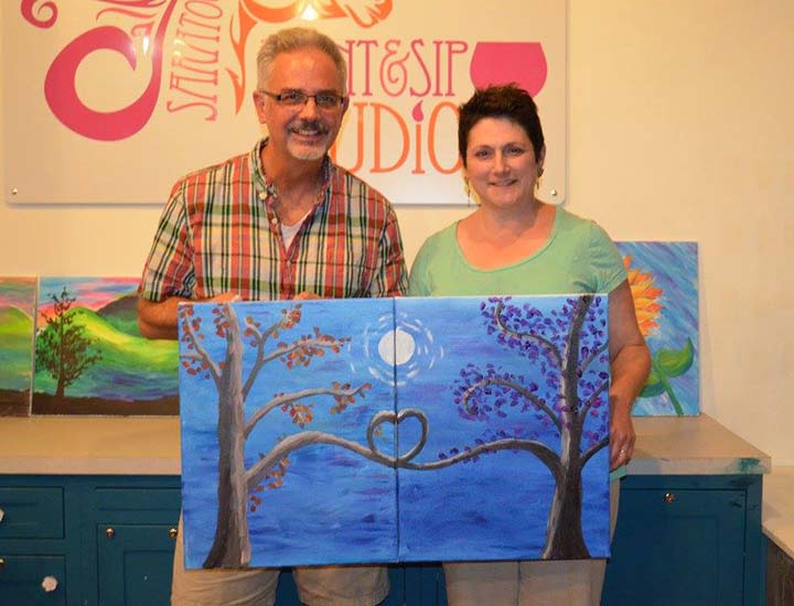 a couple who painted complementary paintings that fit together at a paint & sip partners in crime party